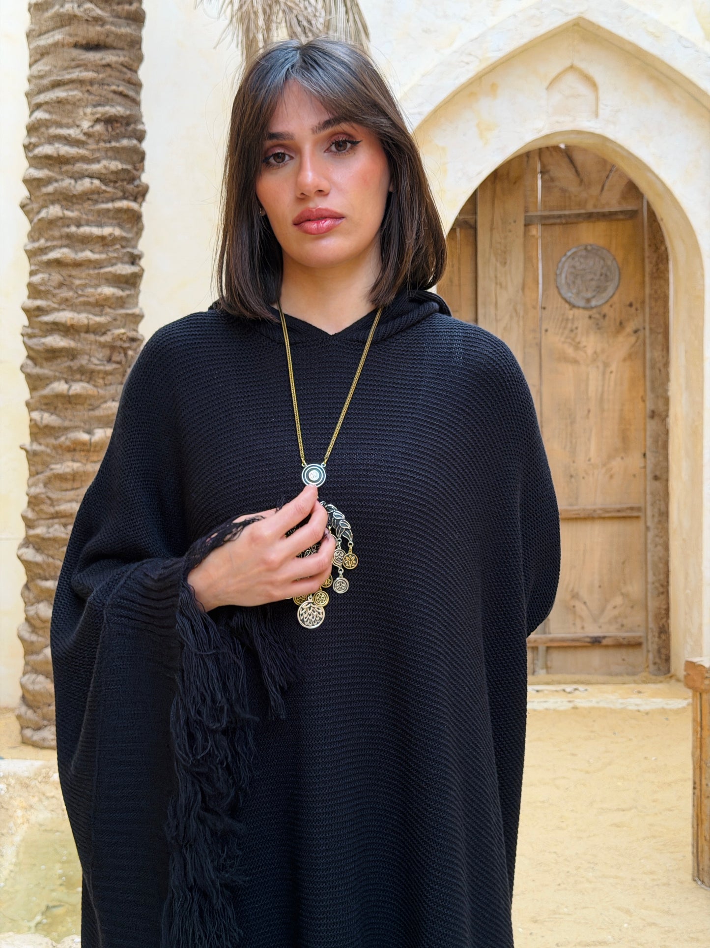 نَفَس — Nafas
Tassel Knitted Cape in black